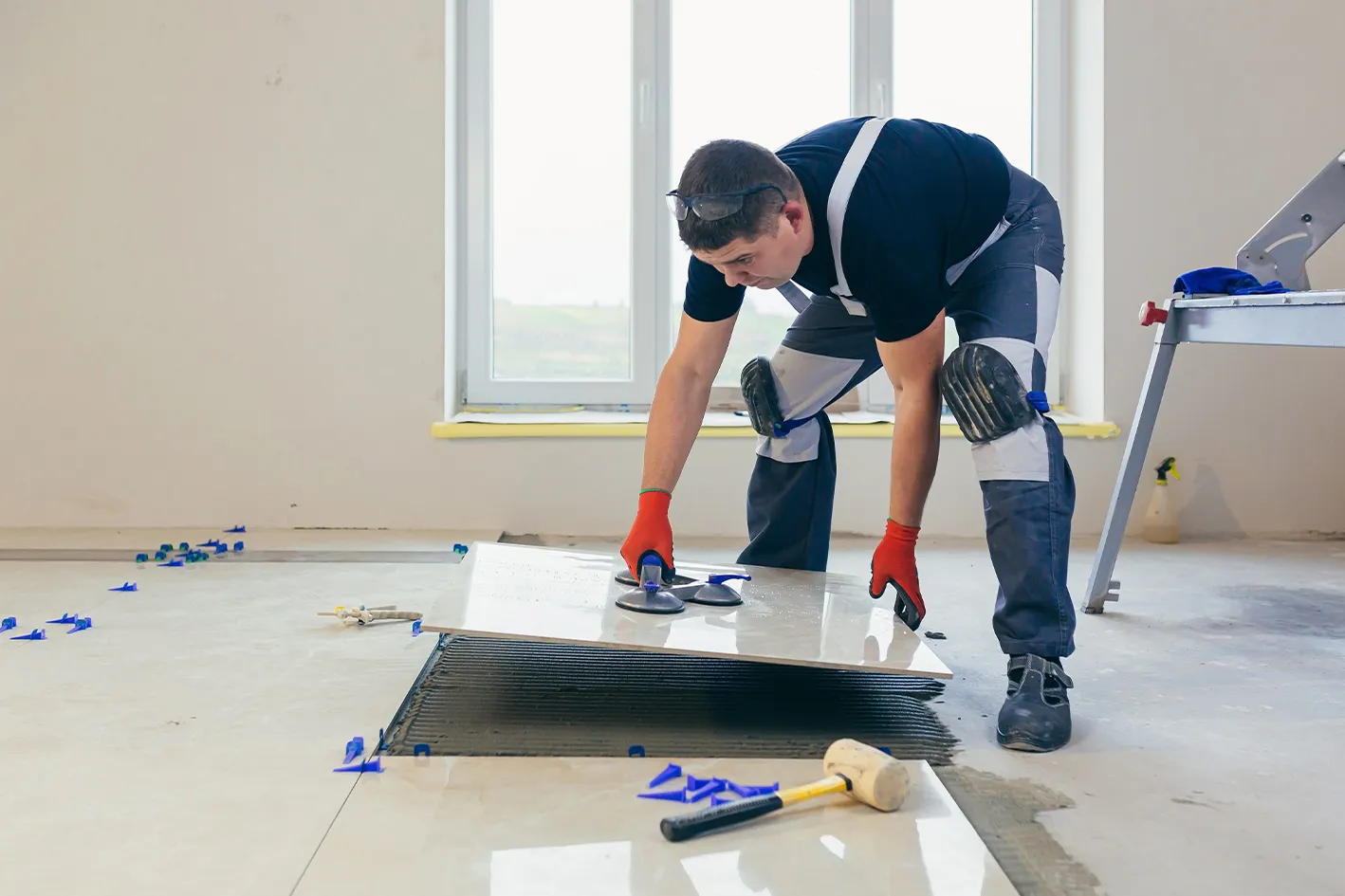 07_stock-photo-a-male-construction-worker-installs-a-large-ceramic-tile-1924514120 (1)